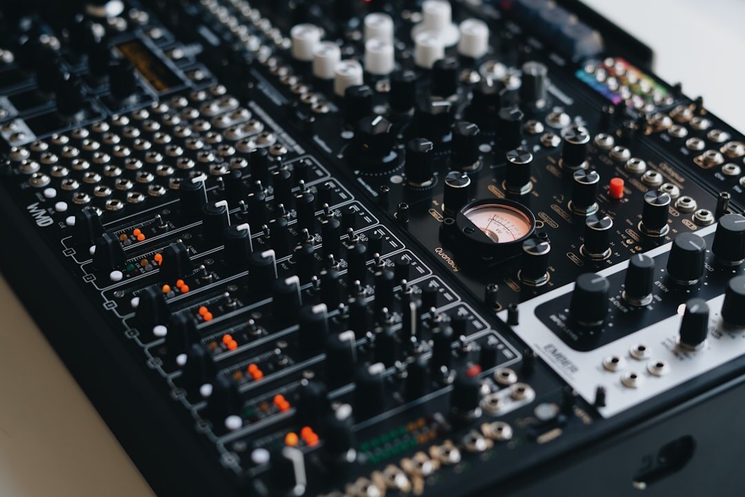 Audio mixing console with sliders and knobs in a recording studio