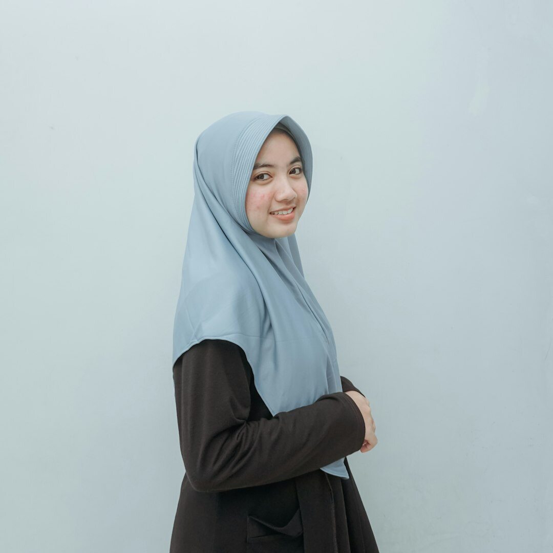 Portrait of a Malay woman wearing a hijab in a studio setting
